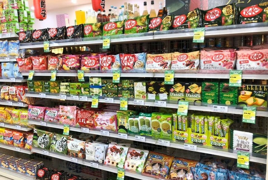 Wide range of Asian groceries lining supermarket shelves.