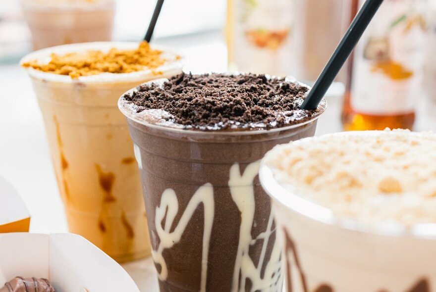 A line up of milkshakes with special toppings.