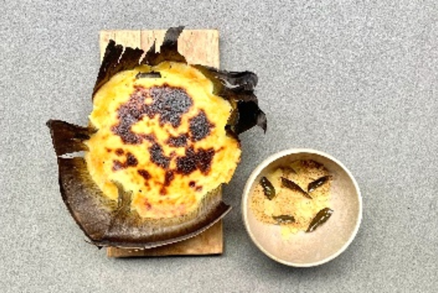 Custard style baked goods served on a banana leaf.