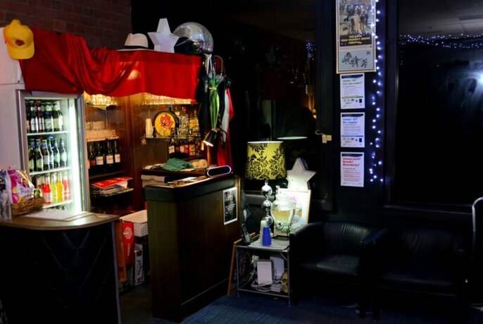 A small bar in a dimly lit club 