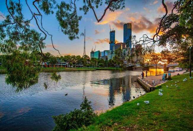 A park beside and a river in the city