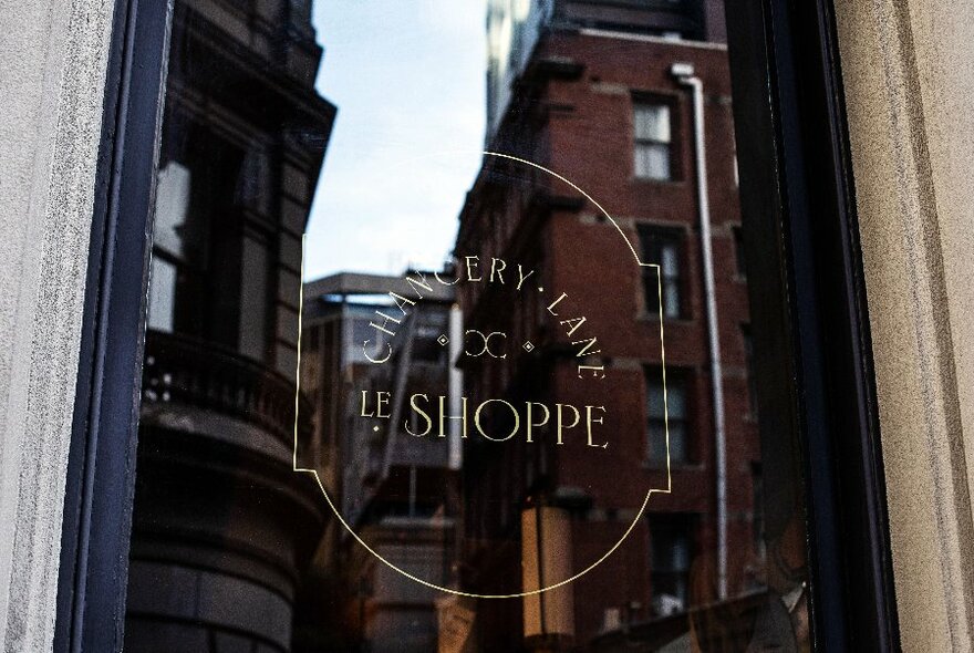 Le Shoppe at Chancery Lane window sign.