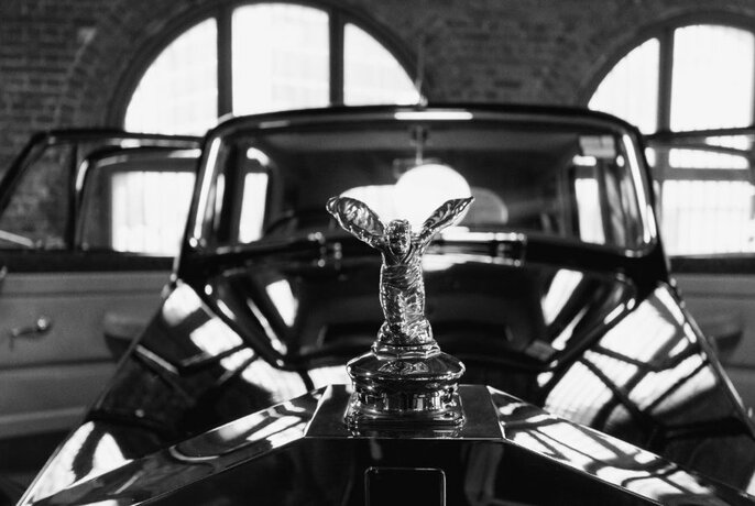 Close-up of a hood ornament on a classic Rolls Royce.