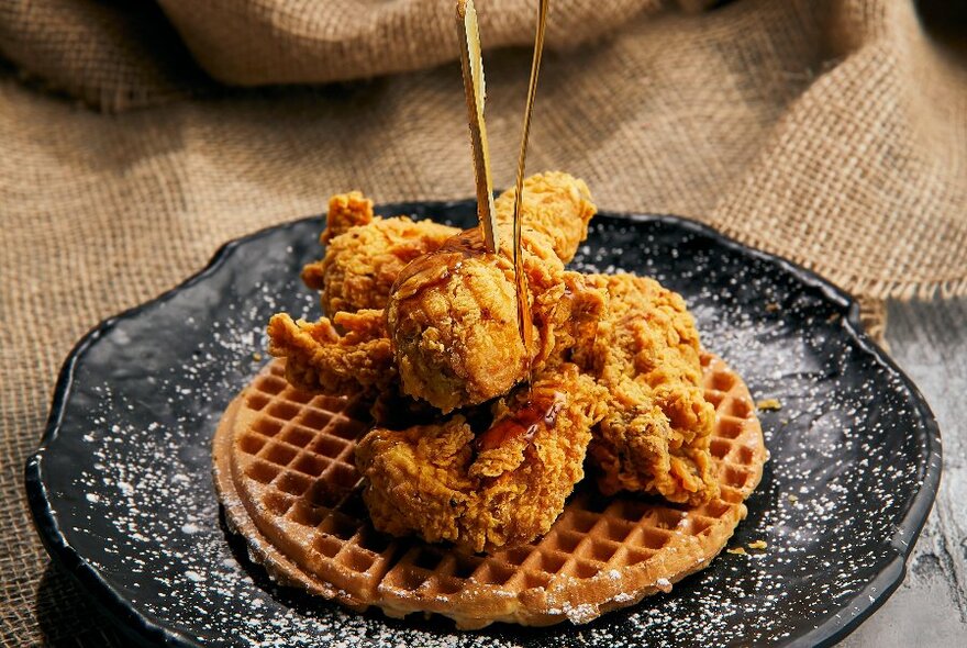 A plate with fried chicken and waffles