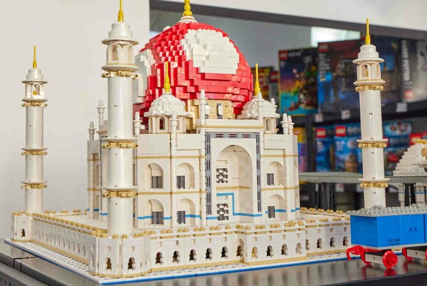 A LEGO sculpture of a large toad character posed behind the Taj Mahal.
