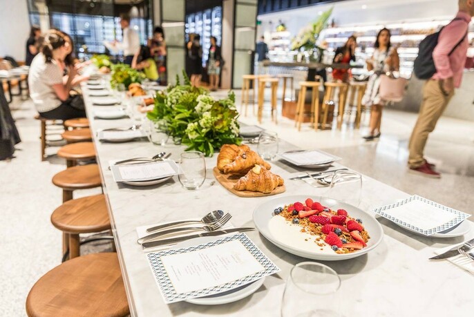 Customers seated at a very long table, in Brunetti Flinders Lane.