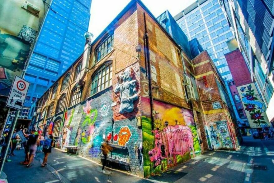 A laneway corner covered in street art.