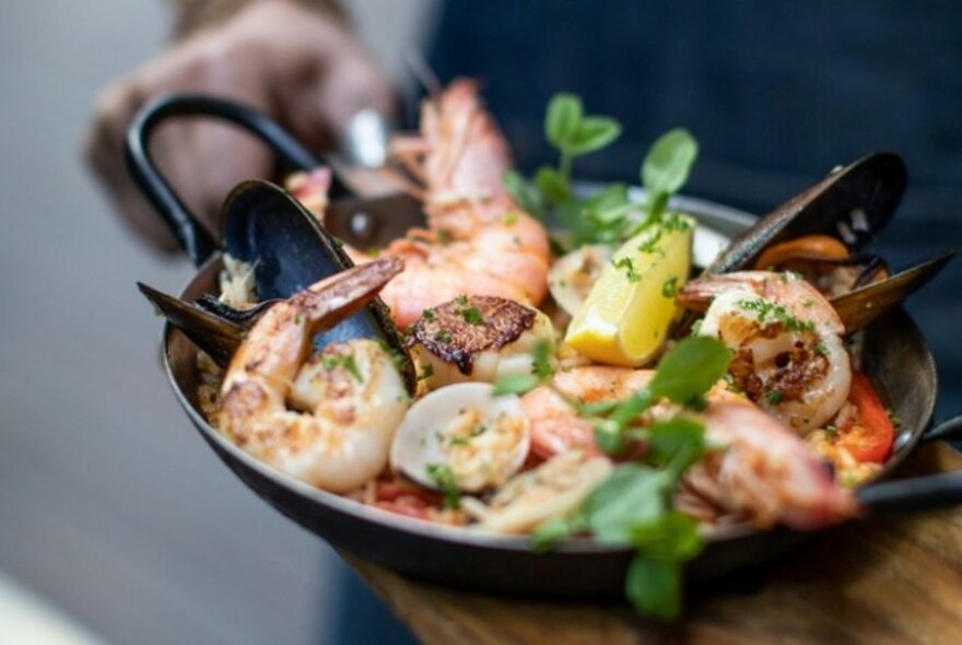 Seafood paella in a cast iron pan.