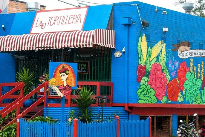 The outside of a brightly coloured restaurant.