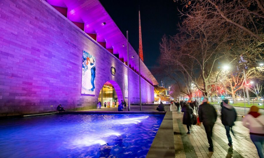The National Gallery Victoria lit up at night.