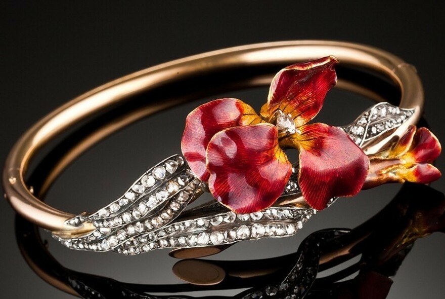 Gold and diamond bracelet with cloisonné red enamelled flower.
