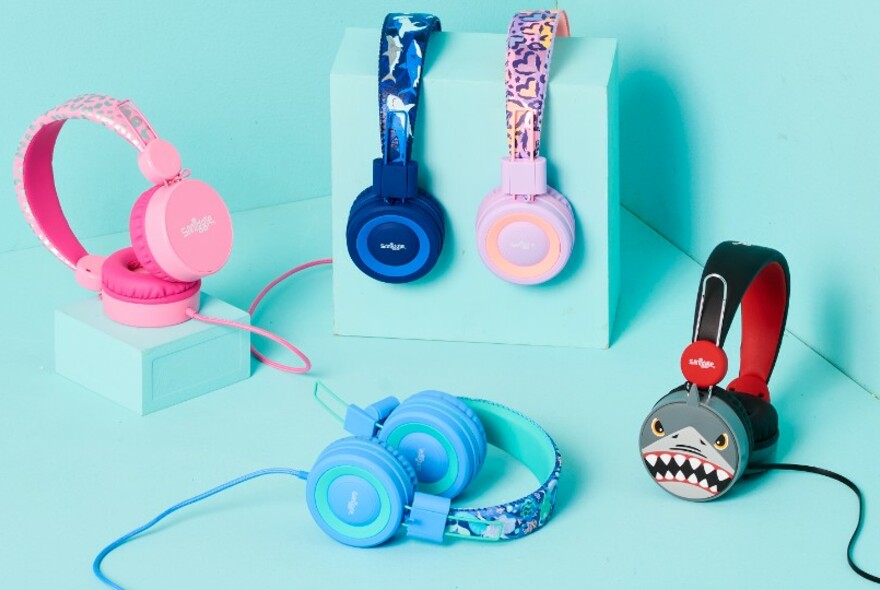Kids' headphones on an aqua background.
