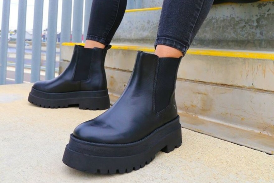 Ankle-length black boots.