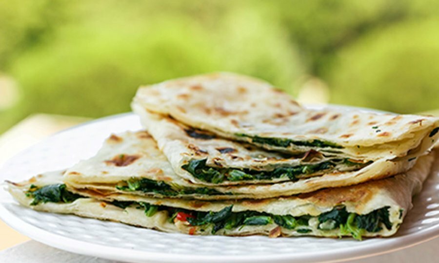 Turkish flat bread pastry on a white plate