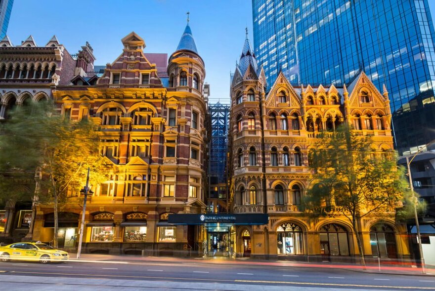 Neo-gothic façade of a building in the city of Melbourne that houses the Rialto Towers behind it.
