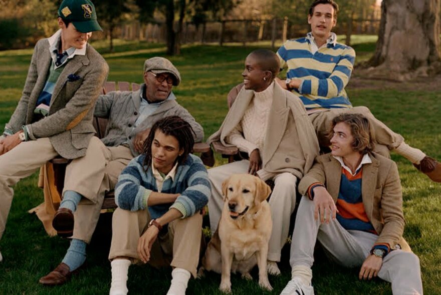 Six people sitting outdoors in a park, all wearing Polo Ralph Lauren clothing.