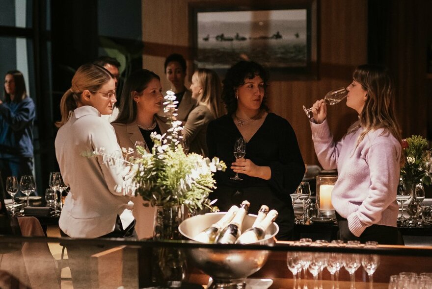 People enjoying a wine-tasting at an exclusive restaurant.