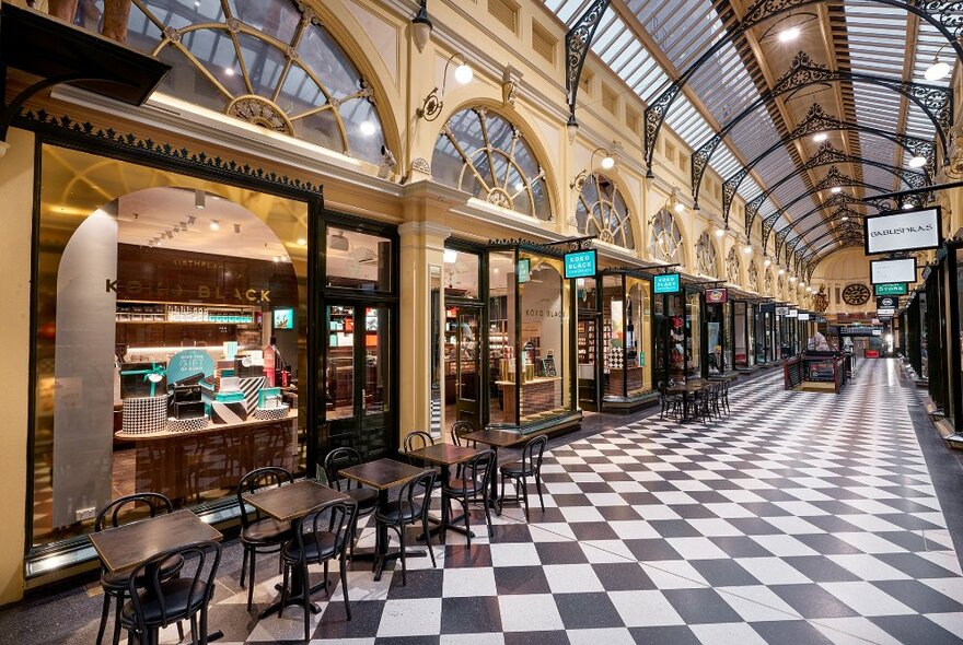 A shopping arcade with checkerboard floors and domed ceilings.